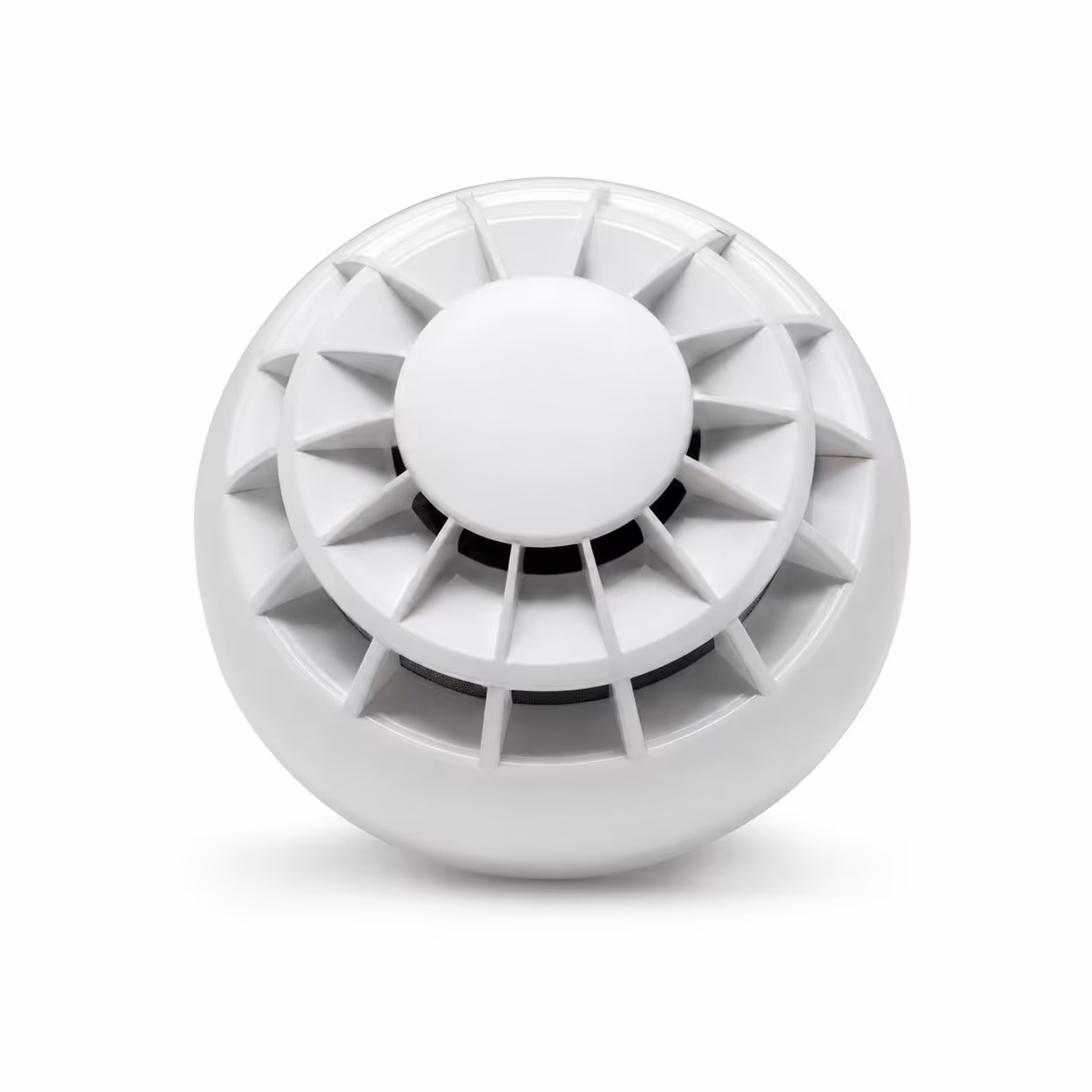 White fire alarm smoke detector with radial vents, shown at an angle on a white background.